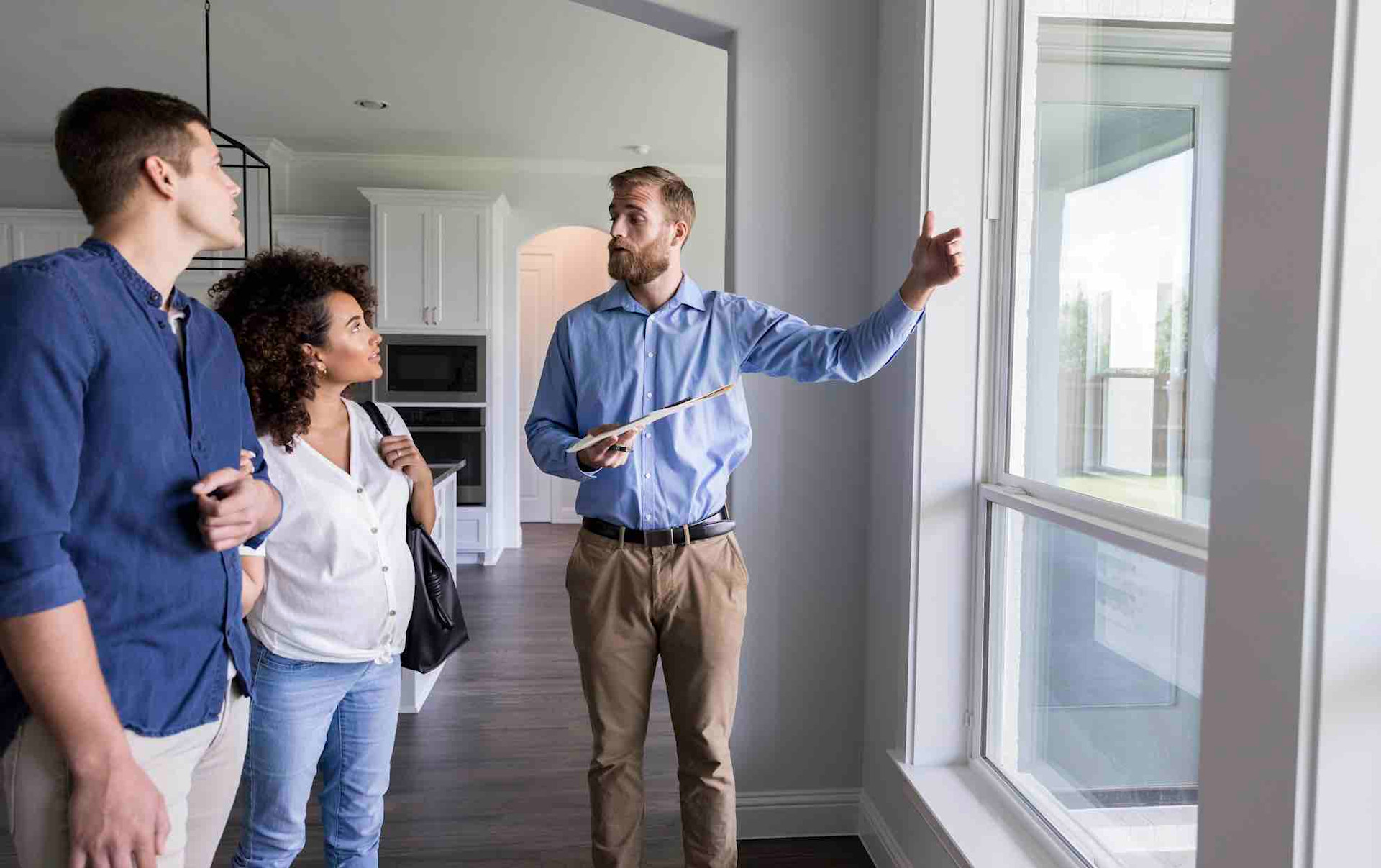Man showing apartment to couple