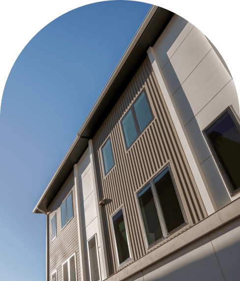 Image of Mynd row homes looking up from the street towards the top floor windows