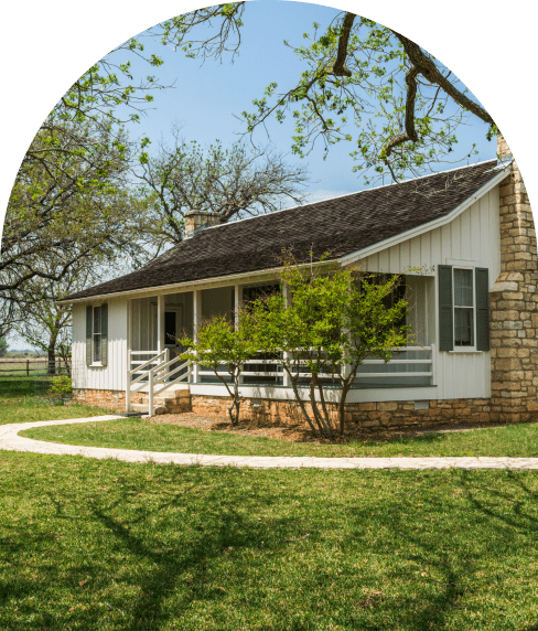 View of a single floor house with a view from the green front lawn